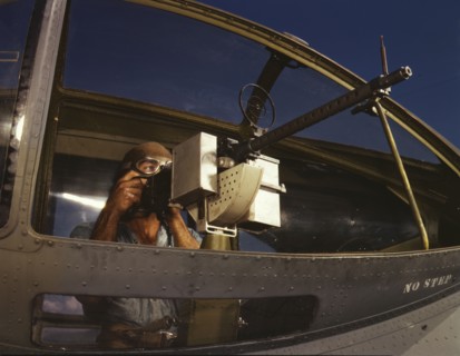 Jesse Rhodes Waller, A.O.M., third class, tries out a 30-calibre...Naval Air Base, Corpus..., 1942. Creator: Howard Hollem.