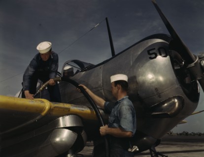 Feeding an SNC advanced training plane its essential supply of gas...Corpus Christi, Texas, 1942. Creator: Howard Hollem.