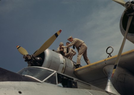 Working on a plane at the Naval Air Base, Corpus Christi, Texas, 1942. Creator: Howard Hollem.