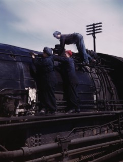 C. & N.W. R.R., women wipers at the roundhouse cleaning one of the giant..., Clinton, Iowa, 1943. Creator: Jack Delano.