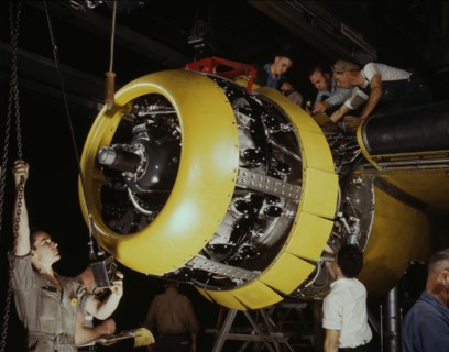 Mounting motor on a Fairfax B-25 bomber, North American Aviation, Inc., Inglewood, Calif., 1942. Creator: Alfred T Palmer.