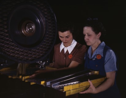Punching rivet holes in a frame member for a B-25 bomber...North American Aviation, Inc., CA, 1942. Creator: Alfred T Palmer.