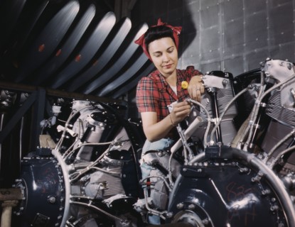 Woman working on an airplane motor at North American Aviation, Inc., plant in Calif., 1942. Creator: Alfred T Palmer.