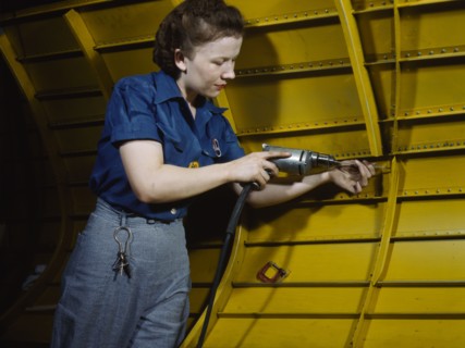 Operating a hand drill at Vultee-Nashville, woman is working on a "Vengeance" dive..., Tenn., 1943. Creator: Alfred T Palmer.