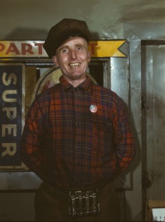 Garage mechanic near Newark, N.J. Badge denotes member of Office of Defense Transportation, 1943. Creator: Marjory Collins.