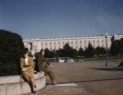 A soldier and a woman in a park, with the Old Russell Senate Office..., Washington, D.C., ca. 1943. Creator: Unknown.