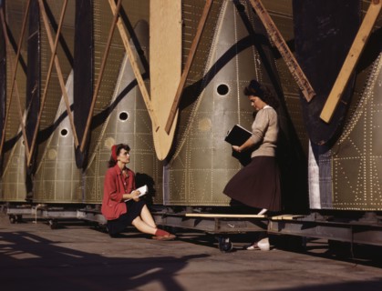 Girl inspectors at the Long Beach, Calif., plant of Douglas Aircraft Company make a careful..., 1942 Creator: Alfred T Palmer.