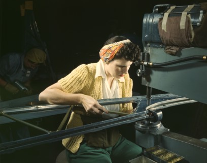 A girl riveting machine operator at the Douglas Aircraft Company plant..., Long Beach, Calif. , 1942 Creator: Alfred T Palmer.