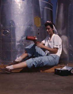 Girl worker at lunch also absorbing Calif..., Douglas Aircraft Company, Long Beach, Calif., 1942. Creator: Alfred T Palmer.