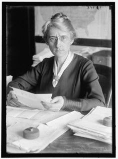 D.E. Thompson, between 1913 and 1918. Woman with paperwork.