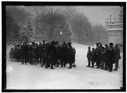 Group outside White House in snow, between 1913 and 1918.