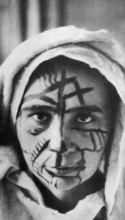 Natalia Goncharova with make-up for the futurist theater, 1913. Private Collection.
