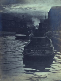 Rear view of tugboats approaching a wharf, possibly in Cleveland, Ohio, 1903.