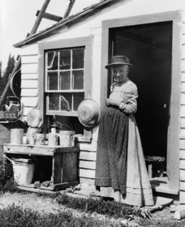 Elderly woman, standing at doorway, on Mackinac Island, Michigan, 1903.