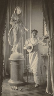Miss Apperson playing banjo beside statue of "Flora" in niche of Sen. George Hearst's residence, Washington, D.C., 1895.