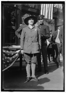 Dora Rodrigues, recruiter for service branches, possibly in front of the Cosmos Theater..., May 1917 Creator: Harris & Ewing.