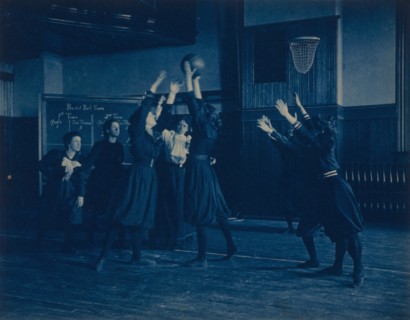 Female students playing basketball in a gymnasium, Western High School, Washington, D.C., (1899?).