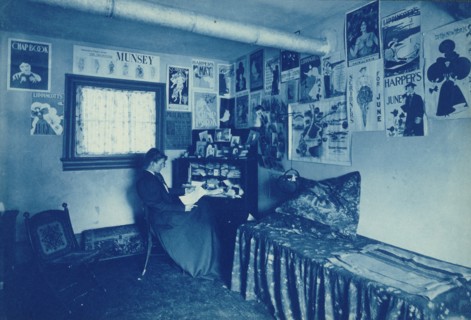 Frances Benjamin Johnston seated at a desk in her studio/office, with adverstising..., c1896. Creator: Frances Benjamin Johnston.