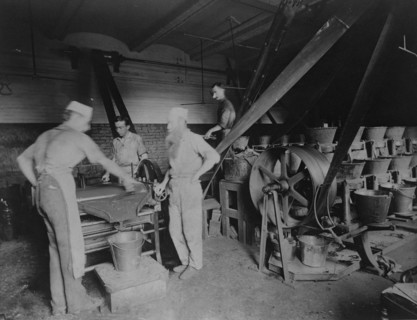 Workers grinding and processing the ink used to print paper money at the Bureau of Engrav..., c1890. Creator: Frances Benjamin Johnston.
