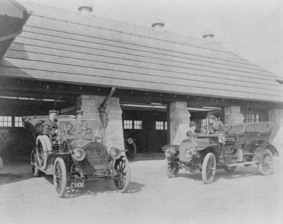Four men with two automobiles outside of garage of Edmund Cogswell..., Greenwich, Connecticut, 1908. Creator: Frances Benjamin Johnston.