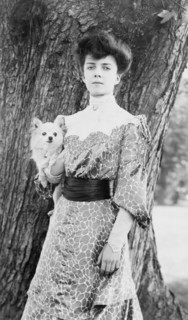 Alice Roosevelt Longworth, three-quarter length portrait, standing in front of tree...dog, c1902. Creator: Frances Benjamin Johnston.