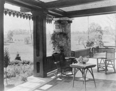 Porch with wicker furniture, and view over lawn to home of Edmund..., Greenwich, Connecticut, 1908. Creator: Frances Benjamin Johnston.