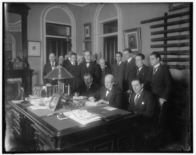 William Jennings Bryan with group at desk, between 1910 and 1920. Creator: Harris & Ewing.