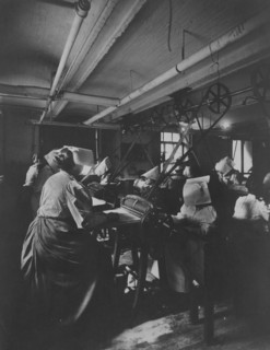 Women perforating sheets of stamps in the Stamp Division at the Bureau of Engraving..., c1895. Creator: Frances Benjamin Johnston.