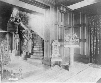 Hall and stairway, with suit of armor at left, and statue of cow..., Greenwich, Connecticut, 1908. Creator: Frances Benjamin Johnston.