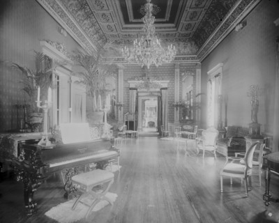 Interior view of a large hall with piano, chairs, small tables, and..., Washington, DC, c1890 - 1910 Creator: Frances Benjamin Johnston.