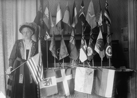 Mrs. Carrie Chapman Catt with Flags of 22 Nations, 1917. Creator: Harris & Ewing.