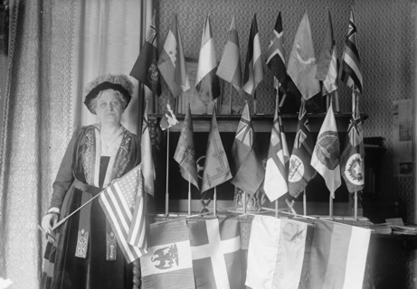Mrs. Carrie Chapman Catt with Flags of 22 Nations, 1917. Creator: Harris & Ewing.