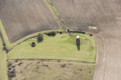 A tower windmill and World War II searchlight emplacements on Halnaker Hill causewayed enclosure, West Sussex, 2018.