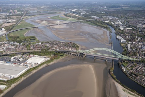 Road and rail bridges over the River Mersey and Manchester Ship Canal at Runcorn Gap, Halton, 2021.