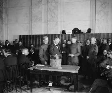 Sec. of the Navy Josephus Daniels drawing draft capsules, between 1910 and 1920.
