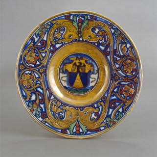 Plate with border of foliate scrollwork with dolphin heads and cornucopias; in the center..., 1524. Creator: Giorgio Andreoli workshop.