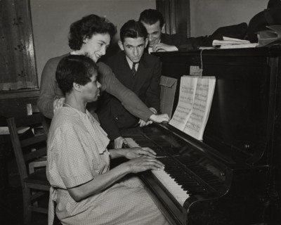 Teacher and student at piano, Jewish Settlement, 1938.