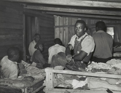 Negroes in bunkhouse in strawberry fields near Hammond, Louisiana; Note crude..., April 1939. Creators: Farm Security Administration, Russell Lee.