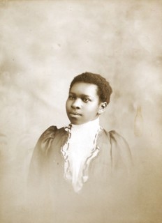 Studio portrait of young woman, c1890-c1899. Creators: M Yogg, Unknown.