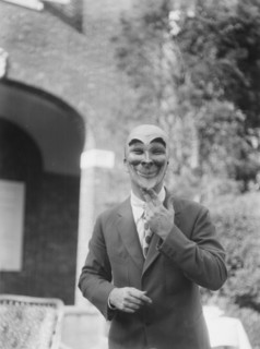 Person wearing a mask made by W.T. Benda, 1925 Sept. 20. Creator: Arnold Genthe.