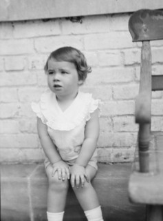 Moseley, F.S., Mr., child of, seated outdoors, 1930 May 24. Creator: Arnold Genthe.