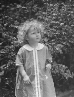 McCormick, Medill, child of, standing outdoors, 1923 May 21. Creator: Arnold Genthe.