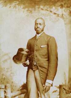 Studio portrait of man with top hat and cane, c1880-c1889. Creator: George E. Curtis.