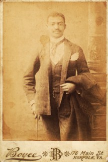 Dapper man, coat draped over his arm, and cane in hand, c1880-c1889. Creator: Unknown.