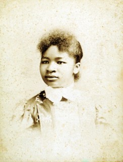 Studio portrait of young woman, head turned to her right, (1880-1900?). Creators: Stanton & Burdick, Unknown.