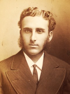 Studio portrait of unidentified man with long sideburns and wavy hair, c1870-c1879. Creator: Moses Parker Rice.