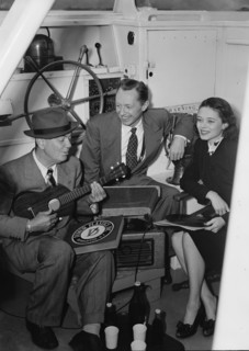 Portrait of Cliff Edwards, Betty Brewer, and Frank..., Ukelele Lady (yacht), Hudson River, NY, 1947. Creator: William Paul Gottlieb.