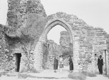 Three women and a man standing in front of ruins, between 1911 and 1942. Creator: Arnold Genthe.