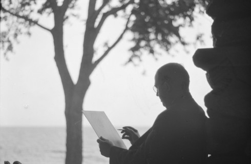 Bruce, Ned, Mr., reading and writing outdoors, 1915? Creator: Arnold Genthe.
