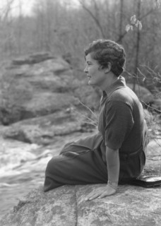 DeLamar, Alice, Miss, seated on a rock, between 1927 and 1942. Creator: Arnold Genthe.